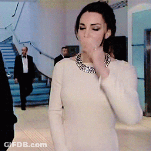 A Woman In A White Dress With A Necklace Around Her Neck GIF