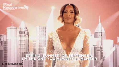 A Woman In A White Dress With The Words " Spring Summer Or September I 'M The One You Always Remember " Behind Her GIF