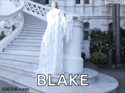 A Woman In A White Dress With Wings Is Standing On A Set Of Stairs With The Name Blake Written On It GIF