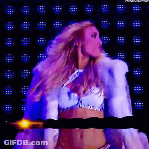 A Woman In A White Fur Coat Is Standing In Front Of A Purple Background GIF