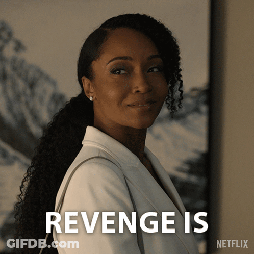 A Woman In A White Jacket Is Standing Next To A Sign That Says " Revenge Is " GIF