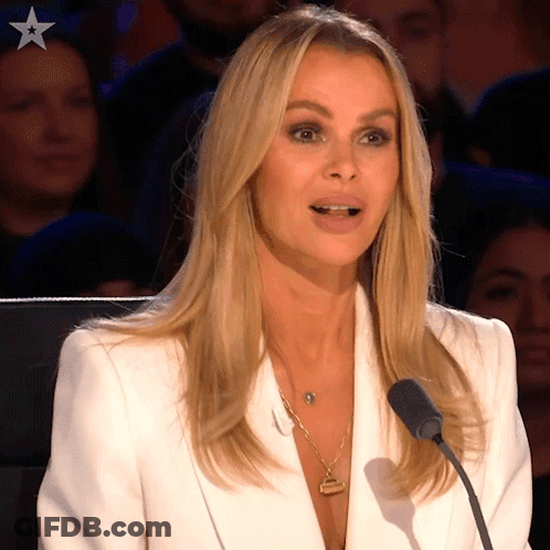 Woman In White Jacket Speaking Into Microphone With Star GIF