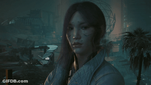 A Woman In A White Jacket Stands In A Dark Room GIF