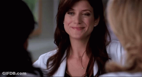 Woman In Lab Coat Smiling And Talking GIF