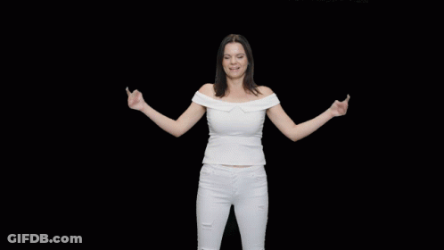 A Woman In A White Off The Shoulder Top And White Jeans Is Dancing GIF