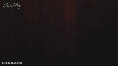 A Woman In A White Robe With The Word Verity On The Bottom Right GIF