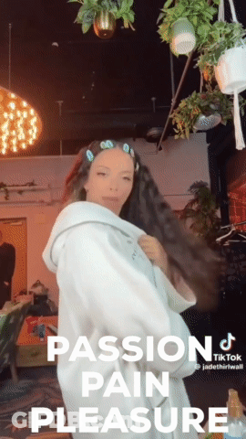A Woman In A White Robe With The Words Passion Pain Pleasure GIF