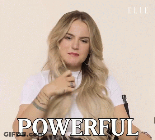 A Woman In A White Shirt Is Holding Her Hair And Says Powerful GIF
