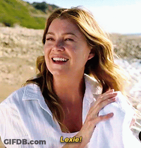A Woman In A White Shirt Is Laughing And Says Lexie GIF