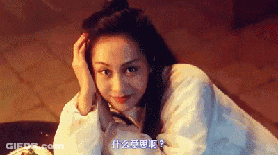 A Woman In A White Shirt Is Laying Down With Her Hand On Her Forehead . GIF
