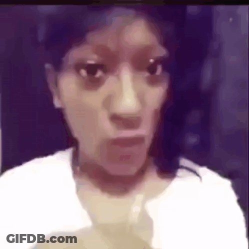 A Woman In A White Shirt Is Making A Funny Face In A Blurry Photo . GIF