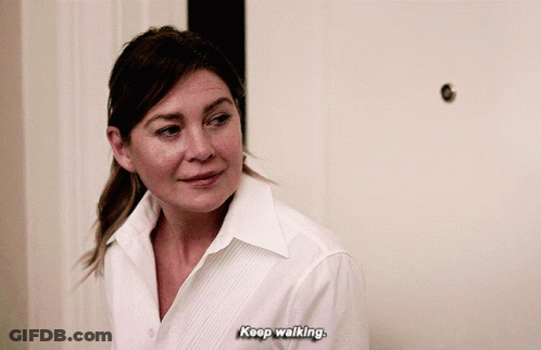 A Woman In A White Shirt Is Saying " Keep Walking " GIF