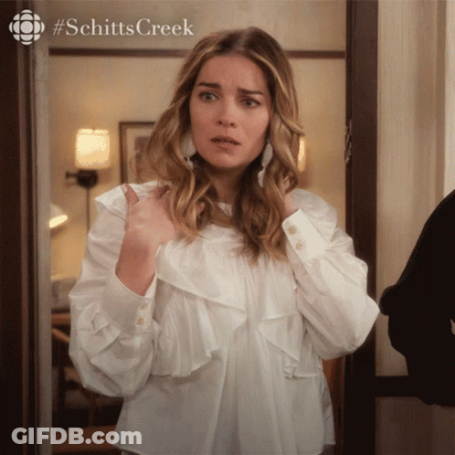 Woman In White Shirt Standing In Doorway Schitts Creek GIF