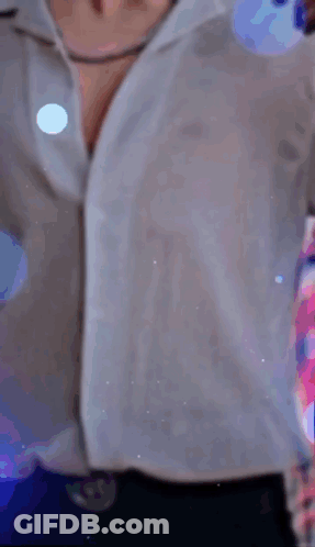 A Woman In A White Shirt Is Standing In Front Of A Sign That Says Tequila N6 GIF