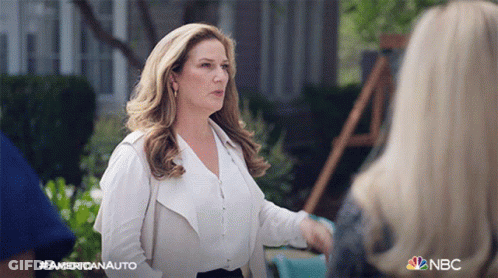 Woman In White Talking To Woman With NBC Logo GIF