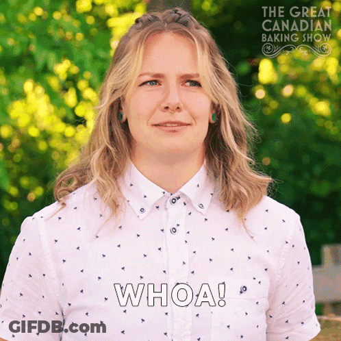 A Woman In A White Shirt Says Whoa In Front Of A Great Canadian Baking Show Logo GIF