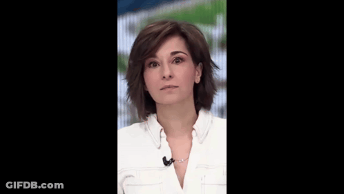 A Woman In A White Shirt With A Microphone On Her Neck Smiles GIF