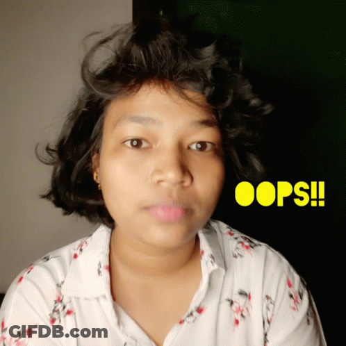 A Woman In A White Shirt With Oops Written In Yellow GIF