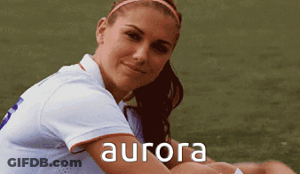 A Woman In A White Shirt With The Word Aurora On The Front GIF