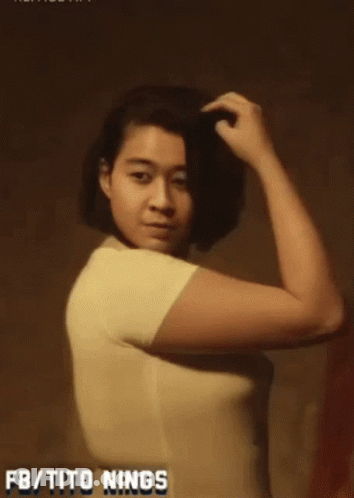A Woman In A White Shirt With The Words Fb / Tito Nings Written On The Bottom GIF