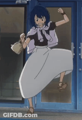 A Woman In A White Skirt Is Standing In Front Of A Door With Her Fist In The Air GIF