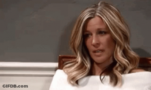 A Woman In A White Sweater Is Sitting In A Chair With Her Eyes Closed . GIF
