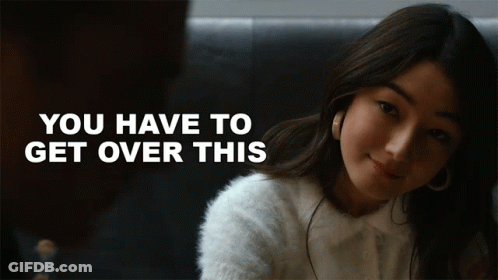 A Woman In A White Sweater With The Words " You Have To Get Over This " Behind Her GIF