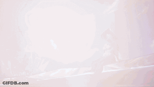 A Woman In A White Swimsuit And Hat Is Sitting In A Pool Of Water GIF