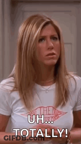 A Woman In A White T-Shirt Is Standing In Front Of A Door And Saying `` Uh ... Totally ! '' GIF
