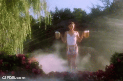 A Woman In A White Tank Top And Pink Shorts Is Holding Two Beer Mugs In Her Hands . GIF