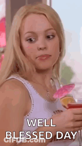 A Woman In A White Tank Top Is Holding A Glass Of Wine And Making A Funny Face . GIF