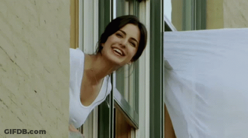 Woman Smiling Looking Out Window GIF