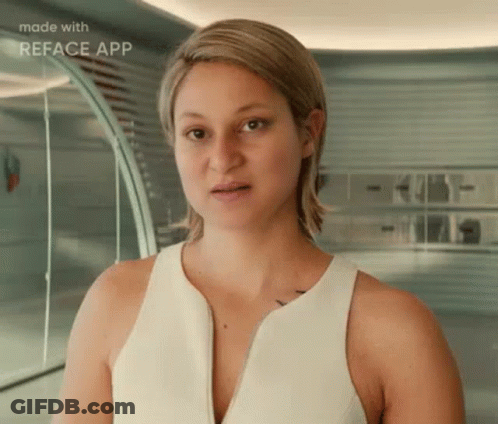 A Woman In A White Tank Top Is Standing In Front Of A Mirror . GIF