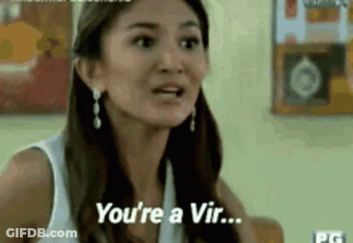 A Woman In A White Tank Top Is Talking To Another Woman And Says `` You 'Re A Vir ... '' . GIF