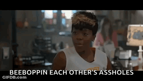 A Woman In A White Tank Top Is Talking To Another Woman In A Room In A Movie . GIF