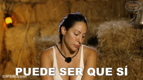 A Woman In A White Tank Top Says " Puede Ser Que Si " In Spanish GIF