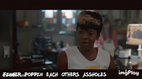 A Woman In A White Tank Top With The Words Finger Poppin Each Others Assholes On It GIF