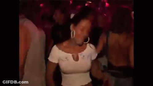 A Woman In A White Top Is Dancing In A Crowd GIF
