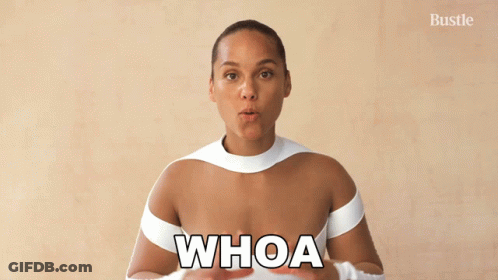 A Woman In A White Top With The Word Whoa On Her Chest GIF