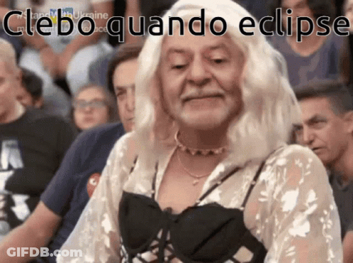 A Woman In A White Wig Is Sitting In A Crowd With The Words " Cleboquando Eclipse " Written On The Bottom GIF