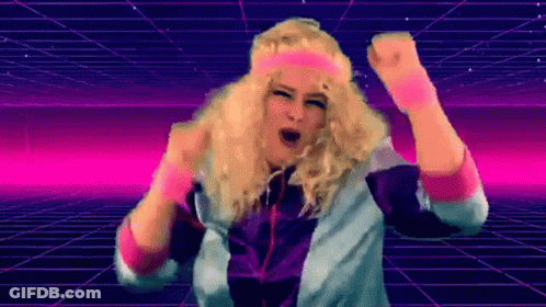 A Woman In A Wig And Headband Is Dancing In Front Of A Grid . GIF