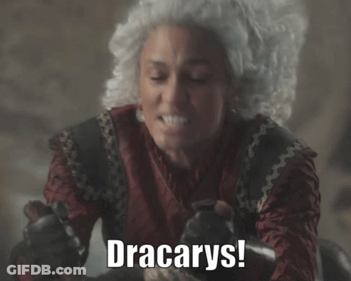 A Woman In A Wig Says " Dracarys " While Holding A Knife GIF