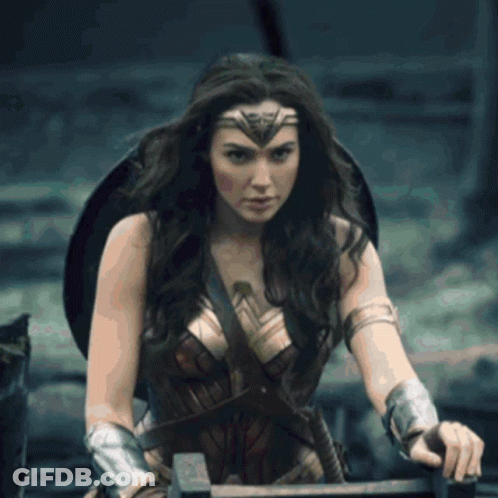 A Woman In A Wonder Woman Costume Holding A Sword GIF