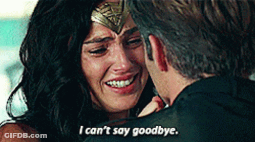 A Woman In A Wonder Woman Costume Is Crying While A Man Holds Her . GIF