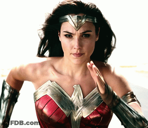 A Woman In A Wonder Woman Costume With A Headband GIF