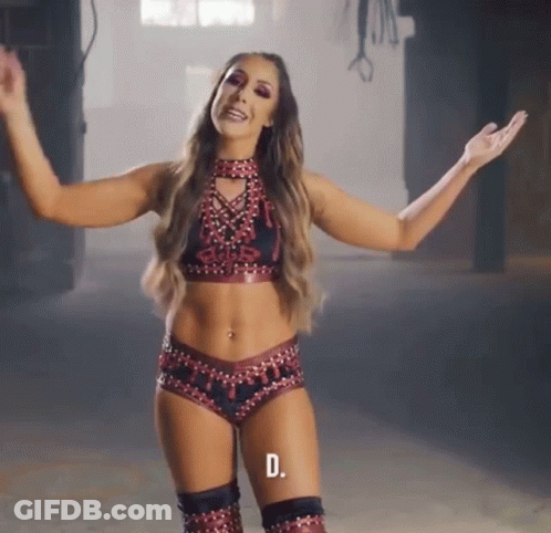 A Woman In A Wrestling Outfit With The Letter D On The Bottom Left GIF