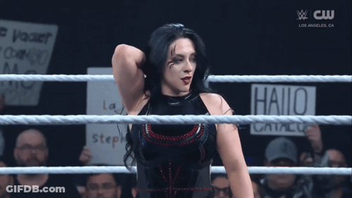 A Woman In A Wrestling Ring Has A Sign That Says Hallo On It GIF