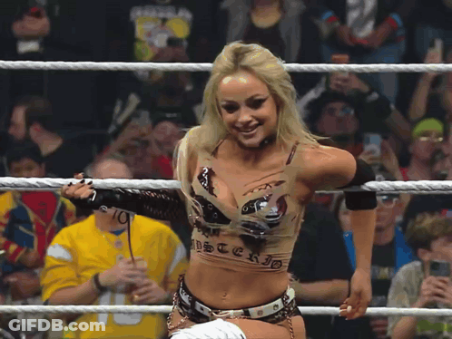 A Woman In A Wrestling Ring Is Wearing A Top That Says Mysterio On It GIF