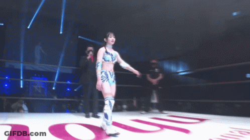 A Woman In A Wrestling Ring Stands In Front Of A Sign That Says ' Oup ' GIF