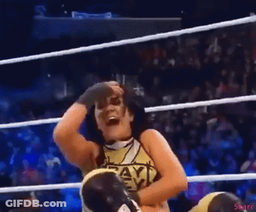 A Woman In A Wrestling Ring Wearing A Shirt That Says Payback On It GIF